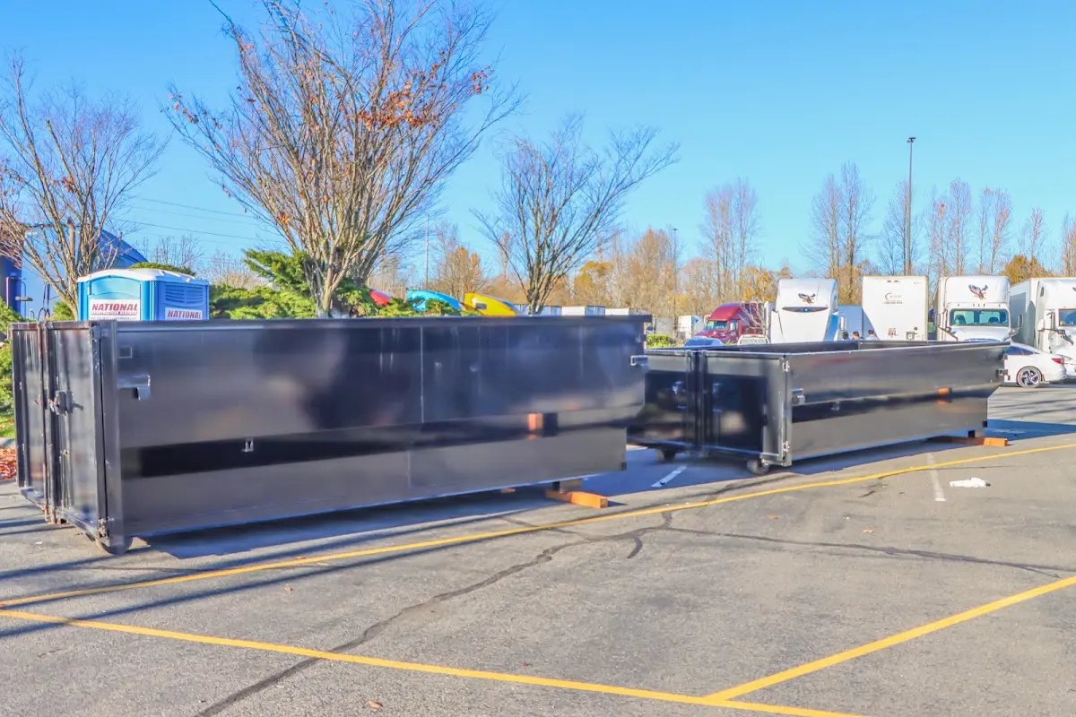 Professional dumpster rental service with roll-off container on residential driveway in Naples Manor